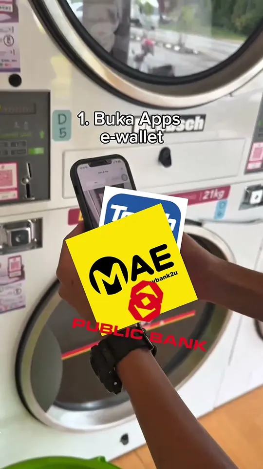 Frame from Byte Bunny's own dryer film: a phone held up to a self-service dryer, ready to pay by QR
