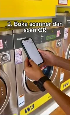 Frame from Byte Bunny's own washer film: two hands hold a phone up to scan the QR on a washer, captioned Buka scanner dan scan QR